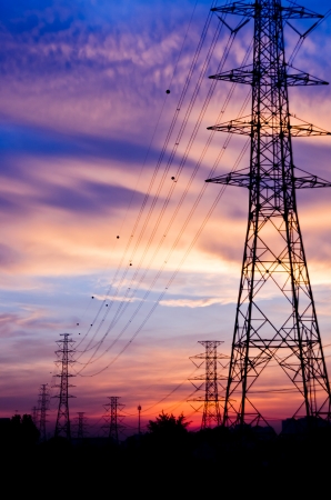High voltage poles on sunsetの写真素材