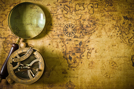 Magnifier with lantern with compass on the old map ,picture style vintage 