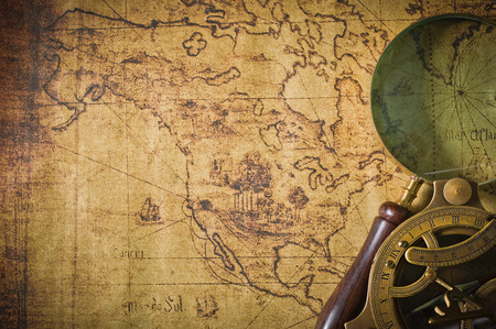 Magnifier with lantern with compass on the old map ,picture style vintage 