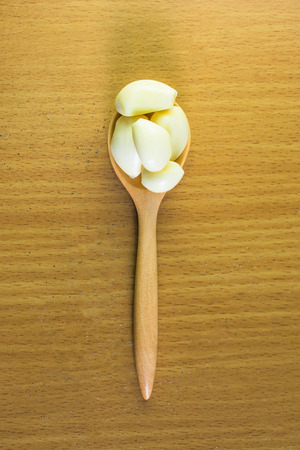 garlic in  wooden spoonの写真素材