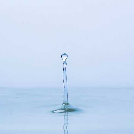 Blue water drop falling downの写真素材