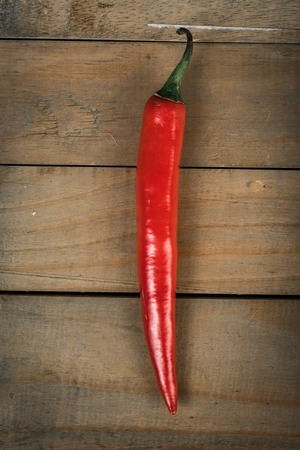 chilli on wood  backgroundの写真素材
