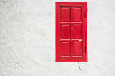 red window on white wallの写真素材