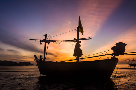 Silhouette of fishing boat at ?he Sunrise in thailand