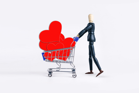 Shopping cart with red hearts paper  on white backgroundの写真素材