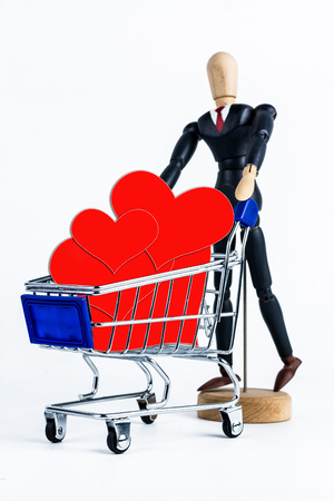 Shopping cart with red hearts paper  on white backgroundの写真素材