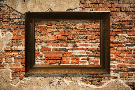 wooden picture frame on old wall backgroundの写真素材
