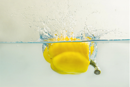 Bell pepper  falls in water .の写真素材