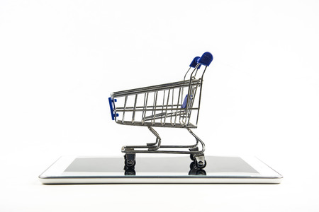 shopping cart with tablet on white backgrond , Means shopping onlineの写真素材