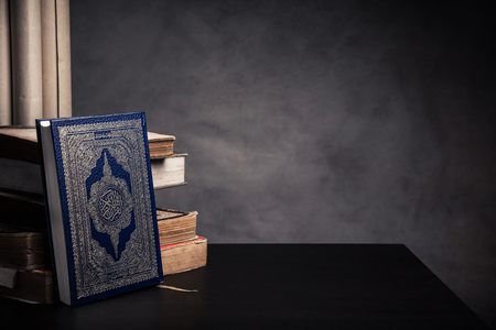 Koran - holy book of Muslims ( public item of all muslims ) on the table , still life .の写真素材