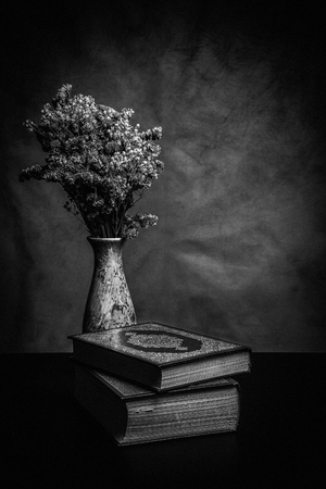Koran - holy book of Muslims ( public item of all muslims ) on the table , still life . Monochrome or black and white の写真素材