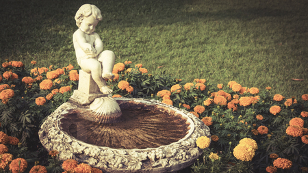 Statue of child in the garden , image vintage  style .の写真素材