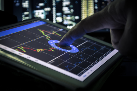 candlestick graph on tablet , Business and financial concept