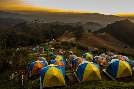 tent in the sunset overlooking mountains .の写真素材