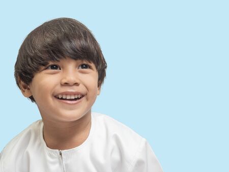 Muslim boy in a dress , isolate background  .