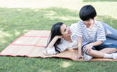 Beautiful mother and son spend a weekend at a picnic in the parkの写真素材