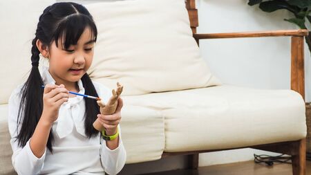 The girl is playing. The girl is painting. Girl enjoying Painting at homeの写真素材