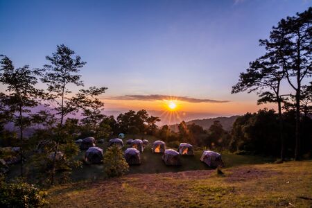 landscape of mountains , sunset ,pine tree ,Camping tent ,Thailand .の写真素材