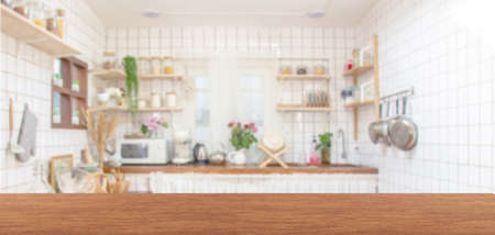 Wood table top on blur kitchen room background .の写真素材