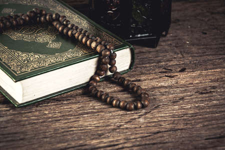 Koran - holy book of Muslims ( public item of all muslims ) on the table , still life .