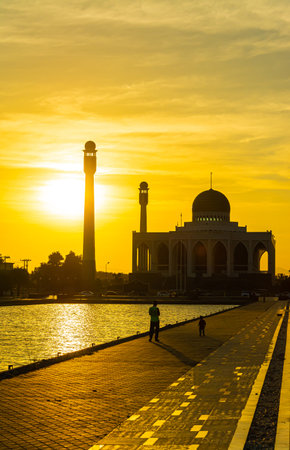 Songkhla Central Mosque in day to night with colorful skies at sunset and the lights of the mosque and reflections in the water in landmark landscape conceptの写真素材