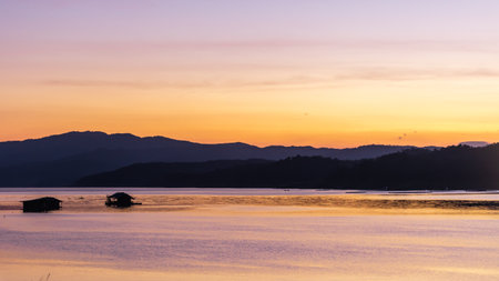 landscape sunset with Reservoir and raft house Thailandの写真素材