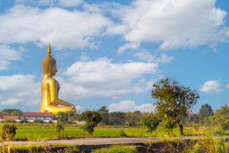 large golden yellow buddha At Wat Muang, which is an important religious tourist destination In Ang Thong Province in Thailand .の写真素材
