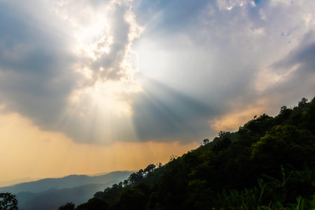 Divine glow through the clouds of the evening warm sun. Concept of peace and happiness.の写真素材