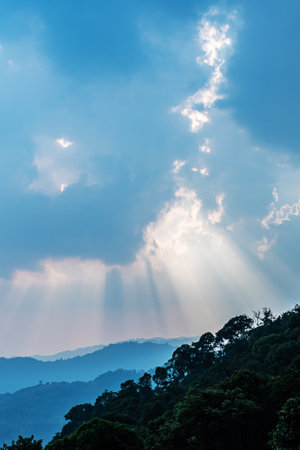 Divine glow through the clouds of the evening warm sun. Concept of peace and happiness.の写真素材