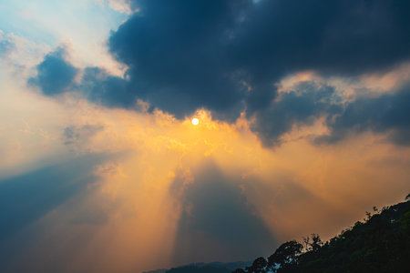 Divine glow through the clouds of the evening warm sun. Concept of peace and happiness.の写真素材