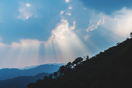 Divine glow through the clouds of the evening warm sun. Concept of peace and happiness.の写真素材