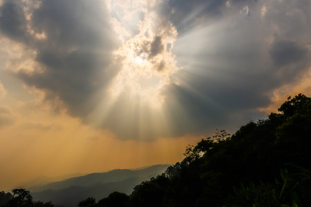 Divine glow through the clouds of the evening warm sun. Concept of peace and happiness.の写真素材