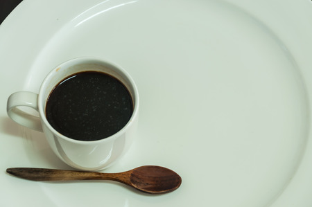 white coffee cup with white dish and spoon on the tableの写真素材