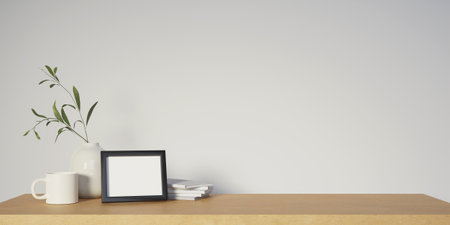 3d picture frame with cup and book on wood top table. 3d rendering, illustrationの写真素材