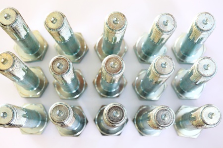 Metal bolts over white and closeup
