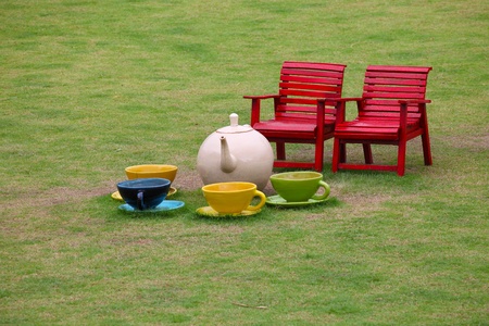 Chairs and ceramice tea set in gardenの写真素材