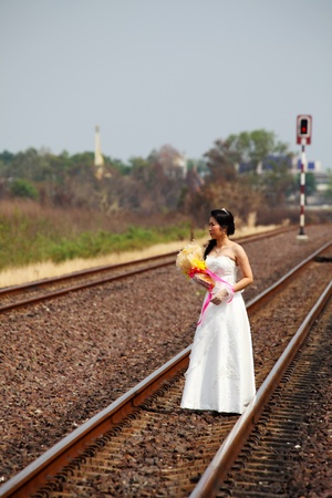 Beautiful Young Bride on A Railway Roadの写真素材
