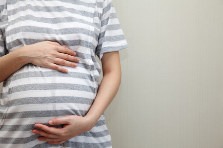 Pregnant Woman Touching Her Bellyの写真素材