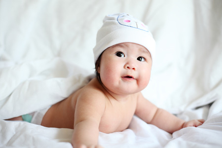 Newborn Baby with Cow Hat Lying Down on a Blanket