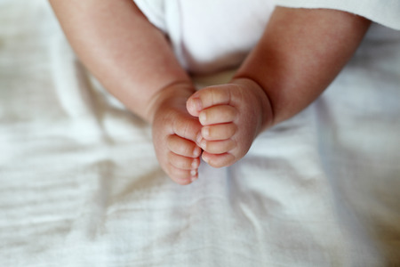 New Born Baby Feet on White Blanket