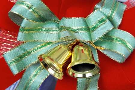 Green bow and golden bell attached to the gift の写真素材