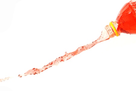 The Red water that spread out from the bottle on The white Background.の写真素材