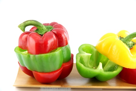Zoom the Three color of bell pepper in the Bamboo dish on white background.の写真素材