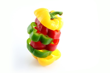 Slice the Three color of bell pepper in Arranged vertically on white background.
