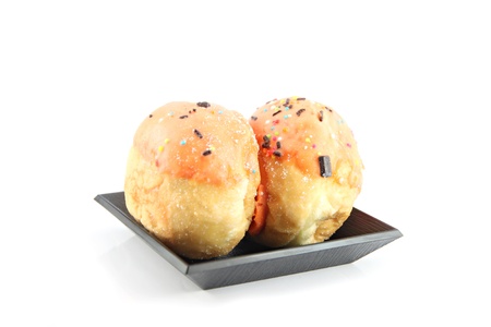The Orange cream donuts in the black dish.の写真素材