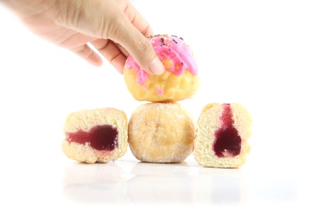 Are hand picked donuts on the white background.の写真素材