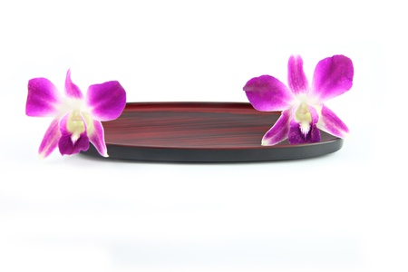 The Purple orchid on a wooden plate.の写真素材