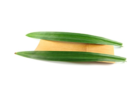 The Purple orchids and pandanus in bamboo dish on the white background.