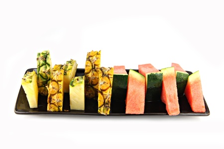 Picture closeup Pineapple and Watermelon slice Arranged in the black dish の写真素材