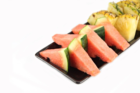 Picture closeup Pineapple and Watermelon slice Arranged in the black dish の写真素材